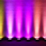 six mad par 4IP on the floor lighting a backdrop in vivid colors