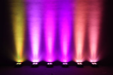 six mad par 4IP on the floor lighting a backdrop in vivid colors