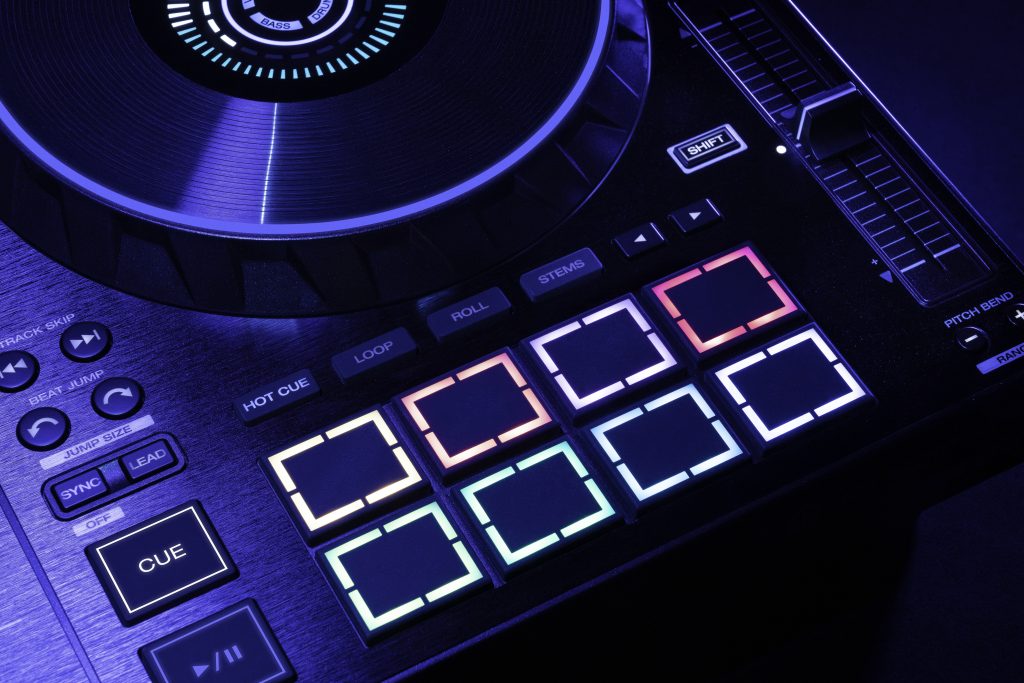 Beauty picture of the right side of the controller with MPC Ebads illuminated, soft purple hue lighting washed the image 